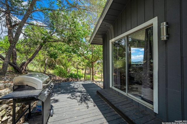 wooden terrace featuring a grill