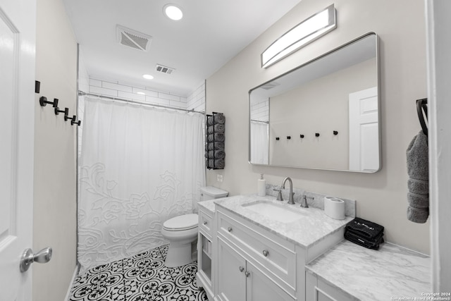 bathroom with tile patterned flooring, vanity, toilet, and curtained shower