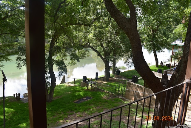 exterior space featuring a water view and a yard