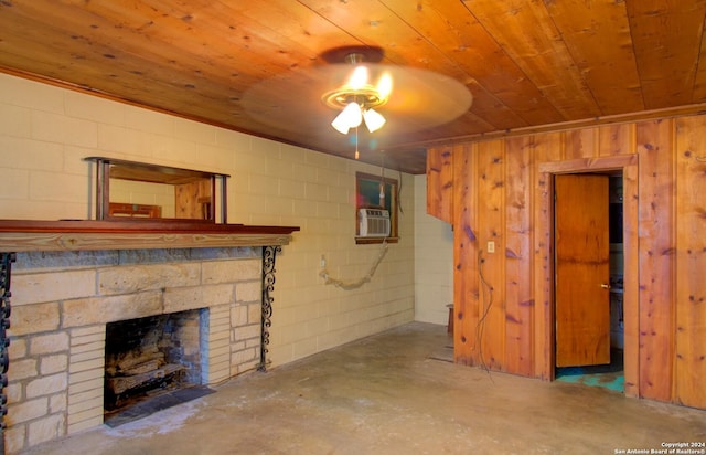 unfurnished living room featuring a ceiling fan, wooden ceiling, concrete block wall, a fireplace, and unfinished concrete floors
