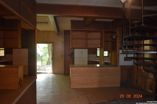 kitchen featuring wood walls and white fridge