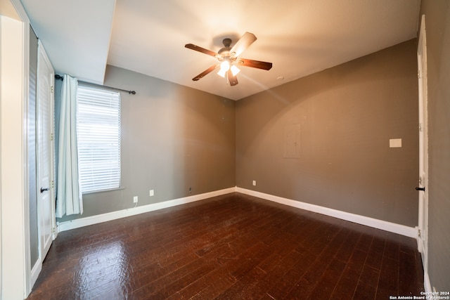 spare room with ceiling fan and dark wood-type flooring