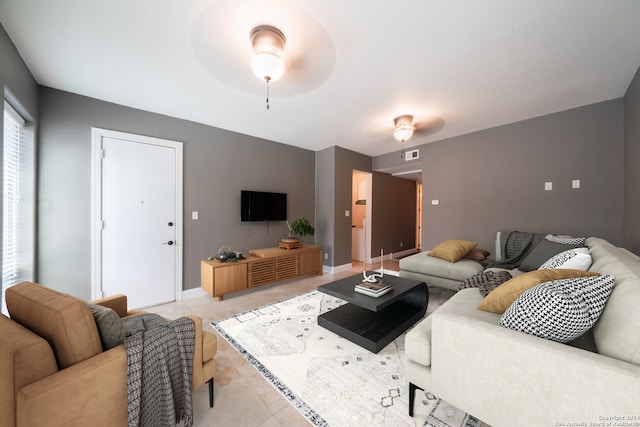 tiled living room featuring ceiling fan