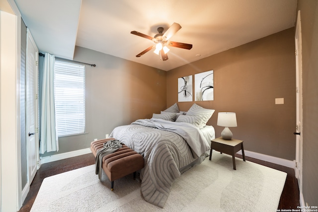 bedroom featuring dark colored carpet and ceiling fan