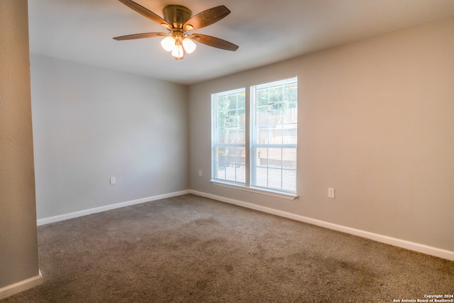 carpeted empty room featuring ceiling fan