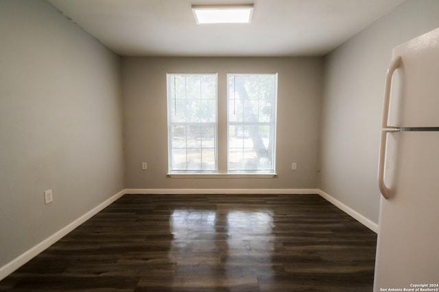 spare room featuring dark wood-type flooring