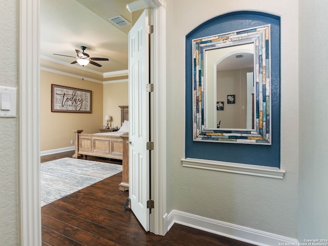 hallway featuring crown molding and dark hardwood / wood-style flooring