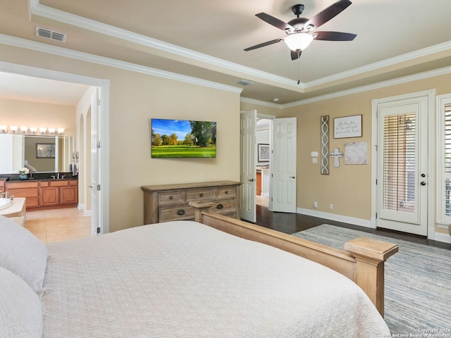 tiled bedroom with ceiling fan, a raised ceiling, access to outside, and ornamental molding