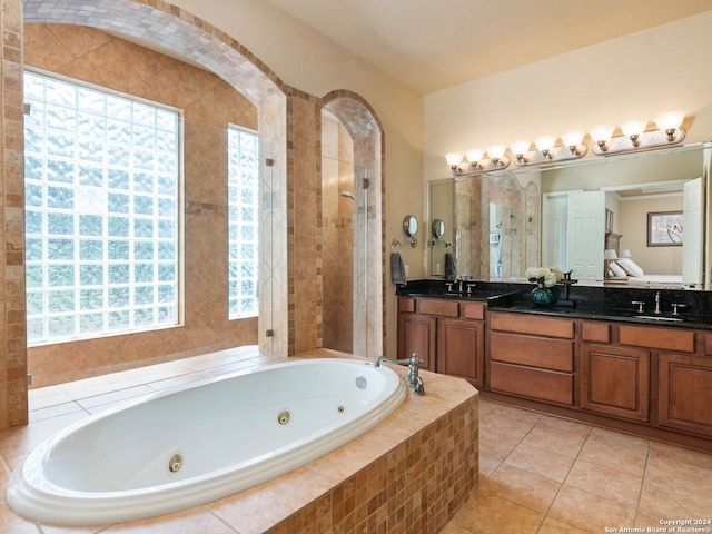 bathroom with a wealth of natural light, vanity, tile patterned flooring, and shower with separate bathtub