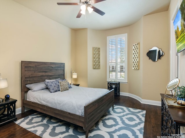 bedroom with ceiling fan and dark hardwood / wood-style floors