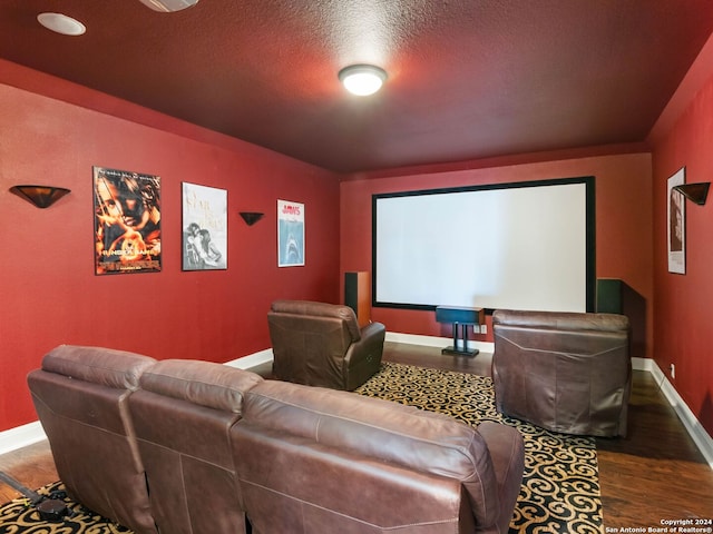 cinema with hardwood / wood-style floors and a textured ceiling