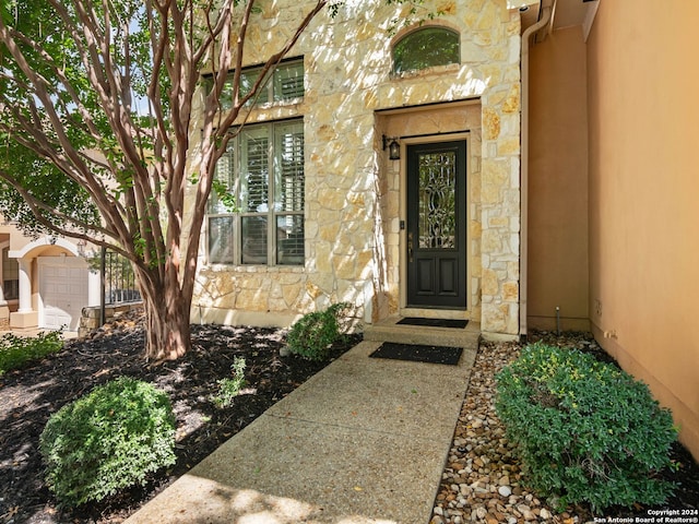 view of exterior entry with a garage