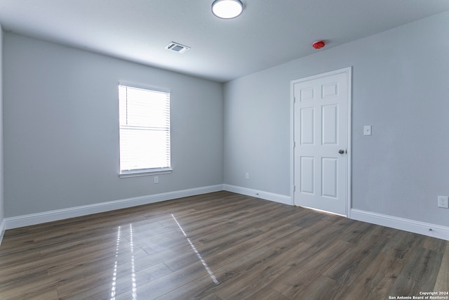 empty room featuring dark wood-type flooring