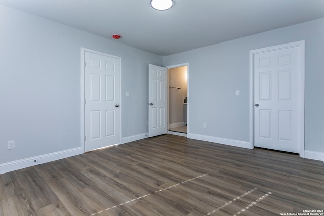 unfurnished bedroom with dark hardwood / wood-style floors