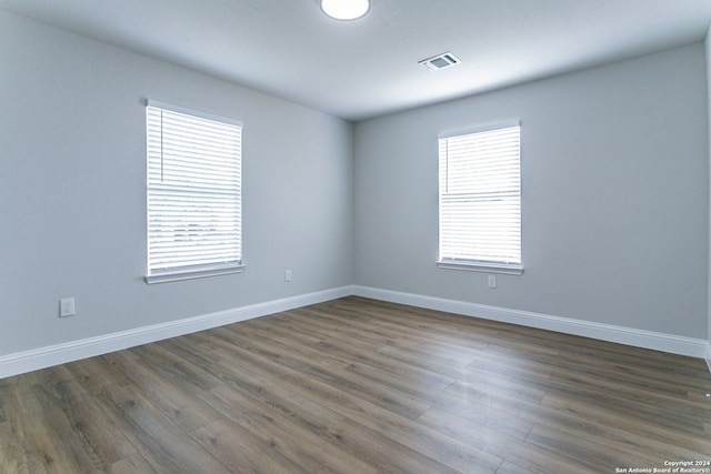 unfurnished room featuring dark hardwood / wood-style flooring