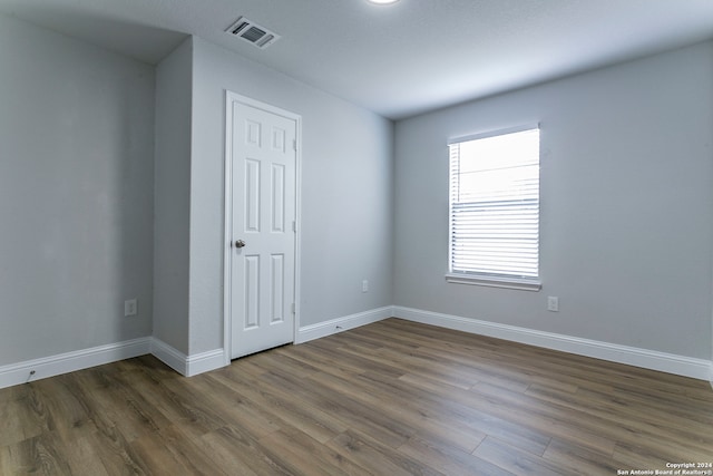 empty room with dark wood-type flooring