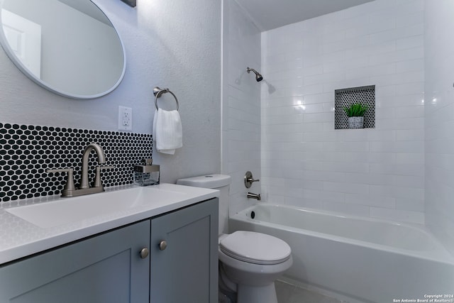 full bathroom with vanity, toilet, tiled shower / bath combo, and backsplash