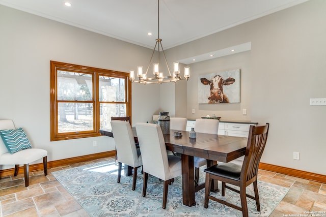 dining room with ornamental molding and a notable chandelier