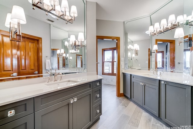 bathroom with a chandelier and vanity