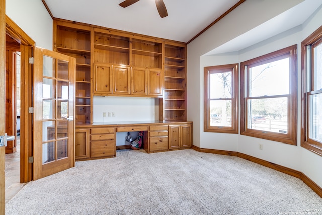 unfurnished office with ornamental molding, light colored carpet, and ceiling fan