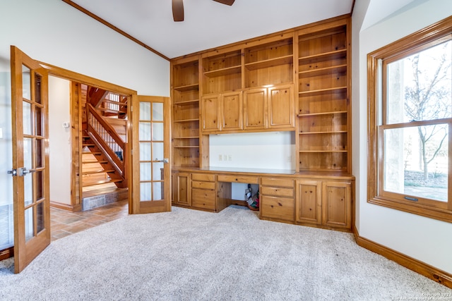 unfurnished office featuring french doors, light colored carpet, a healthy amount of sunlight, and ceiling fan