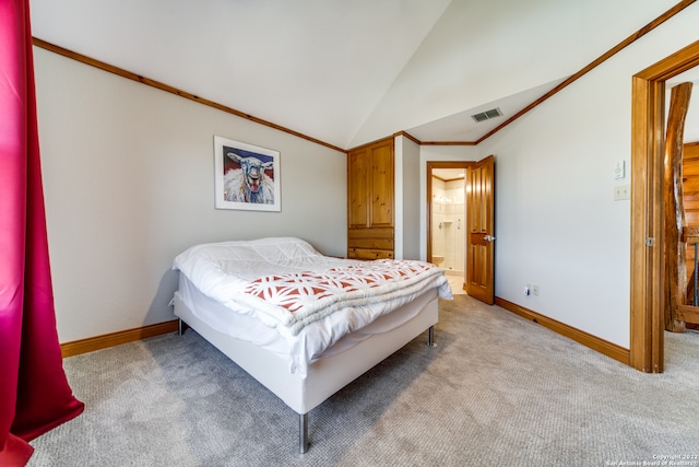 carpeted bedroom with connected bathroom, crown molding, and vaulted ceiling