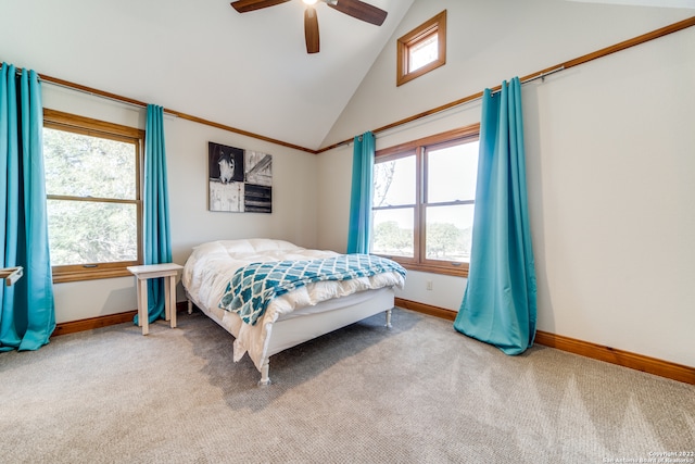 carpeted bedroom with ceiling fan and high vaulted ceiling