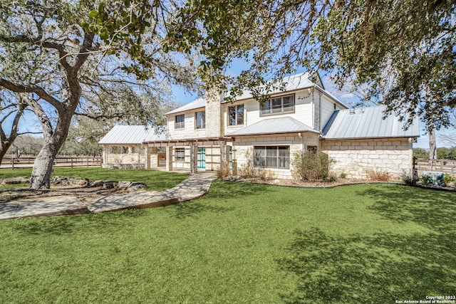 rear view of property featuring a lawn