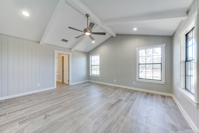 unfurnished room with ceiling fan, light hardwood / wood-style floors, and lofted ceiling with beams