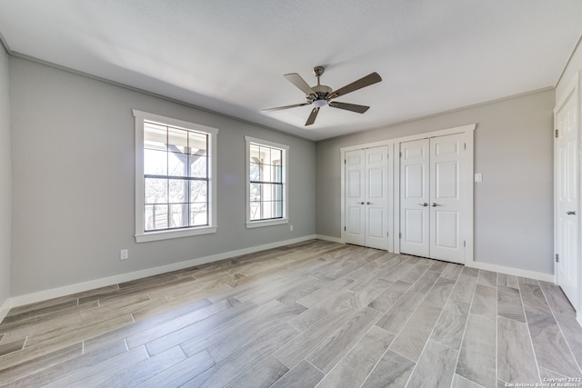 unfurnished bedroom with ceiling fan and light hardwood / wood-style floors