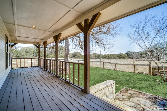 wooden deck featuring a yard