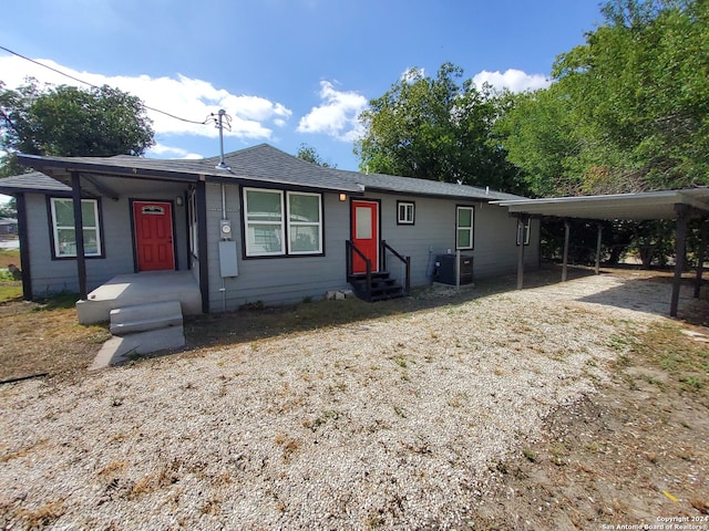 view of front of house featuring a carport and central AC