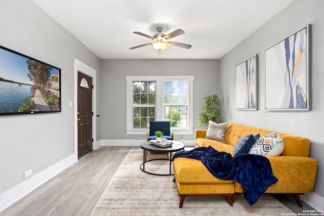 living room with light wood-type flooring and ceiling fan