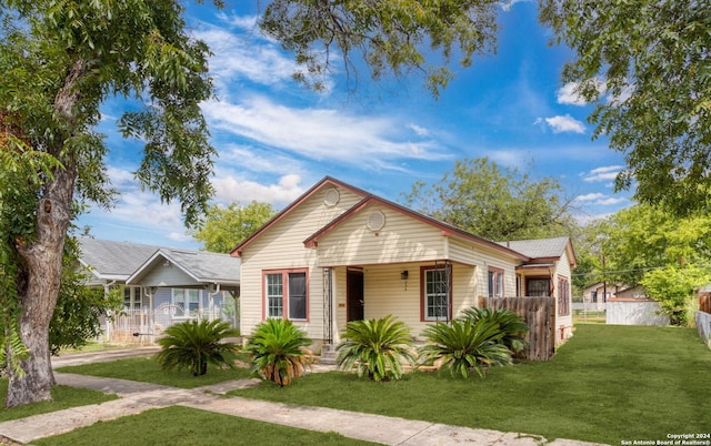 bungalow-style home featuring a front yard and a porch