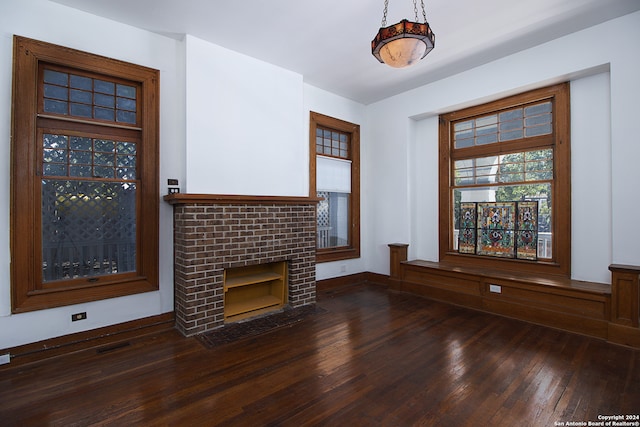 unfurnished living room featuring a fireplace and dark wood-type flooring