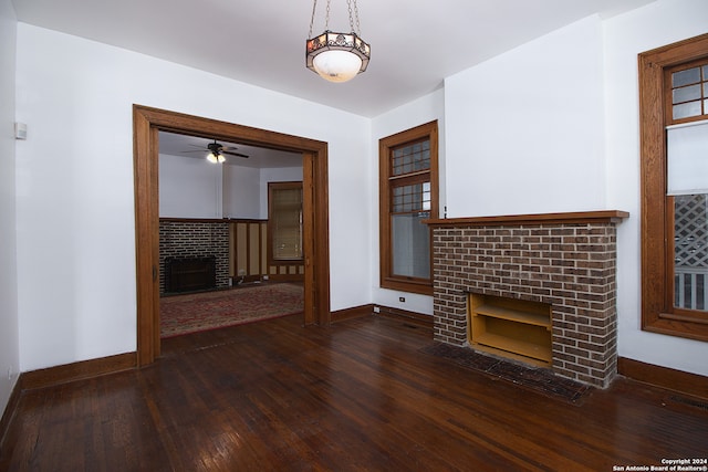 unfurnished living room with ceiling fan, dark hardwood / wood-style flooring, and a fireplace