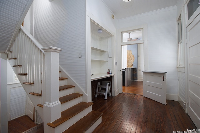 stairway with plenty of natural light, ornamental molding, and hardwood / wood-style flooring