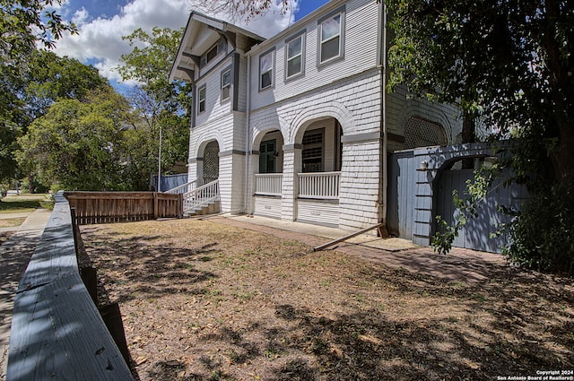 view of side of home with covered porch