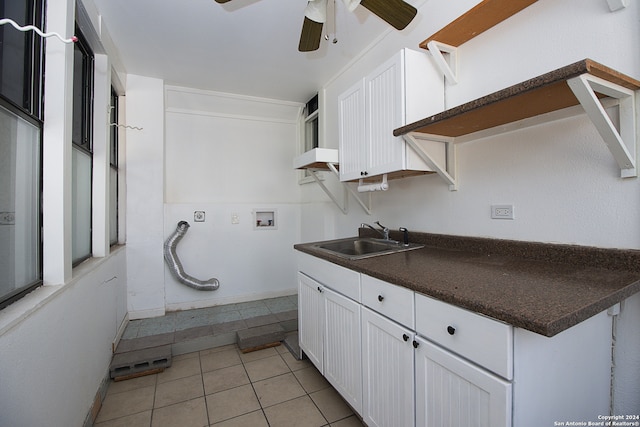 kitchen featuring ceiling fan, sink, white cabinets, and light tile patterned flooring