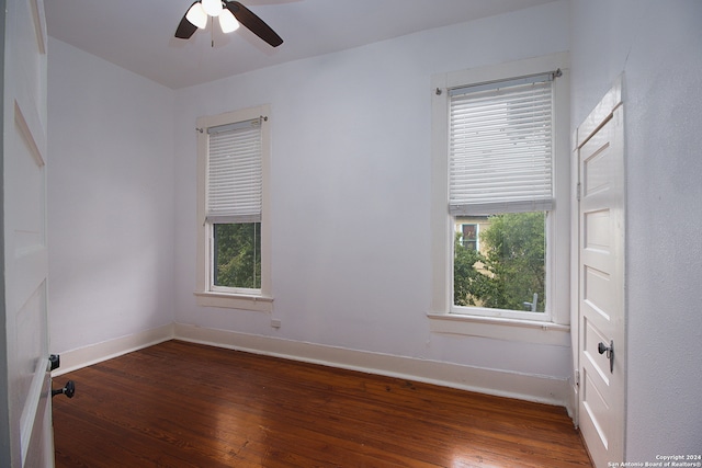 spare room featuring ceiling fan and dark hardwood / wood-style flooring