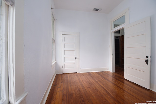 unfurnished room featuring dark hardwood / wood-style flooring