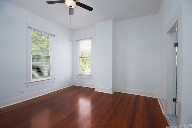 unfurnished room with ceiling fan and dark hardwood / wood-style flooring