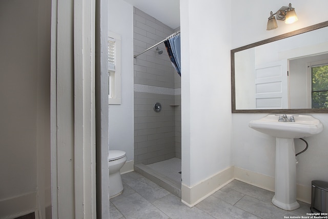 bathroom with a shower with curtain and toilet