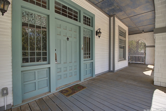 view of exterior entry featuring covered porch