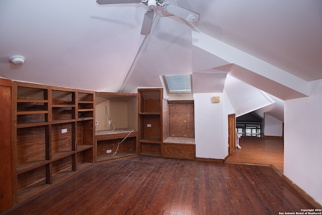 additional living space with ceiling fan, dark hardwood / wood-style floors, and vaulted ceiling