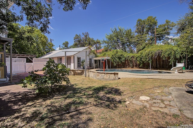 view of yard with a fenced in pool and a patio area