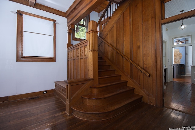 stairs with hardwood / wood-style flooring and beam ceiling