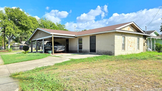 exterior space featuring a carport and a front lawn