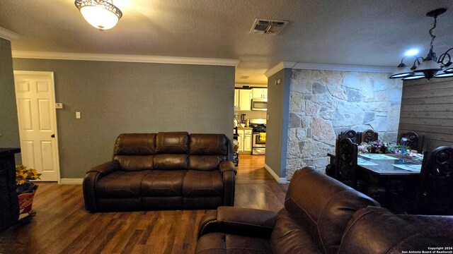 living room with ornamental molding, a textured ceiling, and wood-type flooring