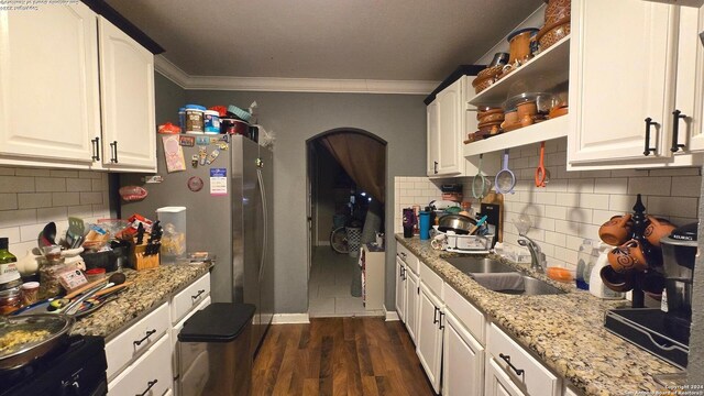 kitchen featuring dark wood-type flooring, crown molding, white cabinetry, and sink